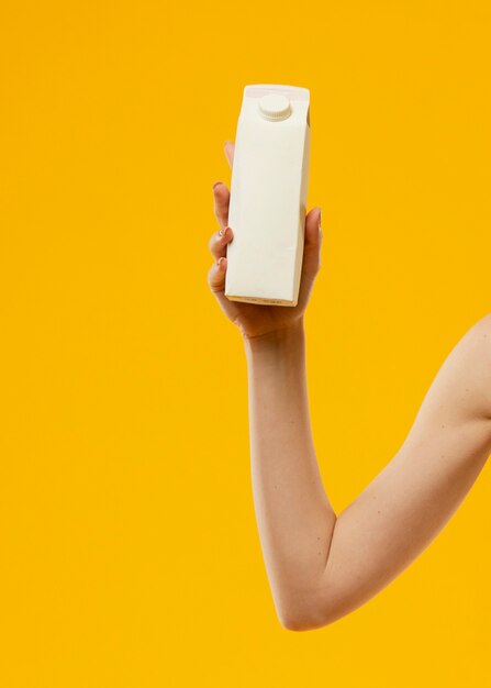 Front view of woman holding a milk bottle