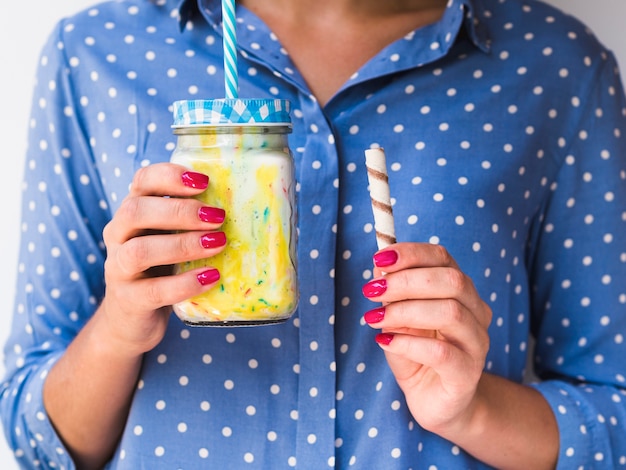 Free photo front view of a woman holding a milkshake