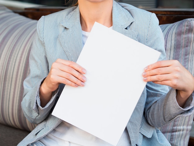 Front view woman holding a mock-up magazine