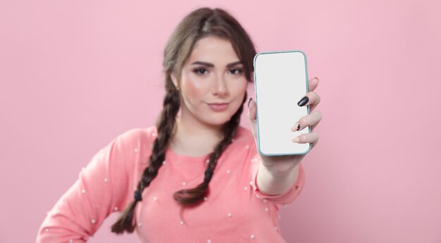 Front view of woman holding out smartphone