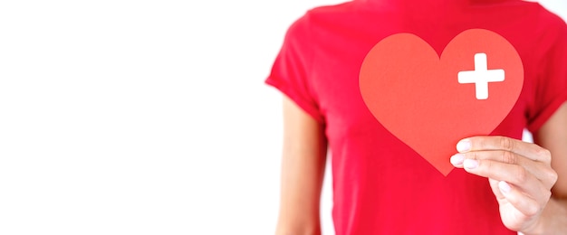 front view of woman holding paper heart with copy space