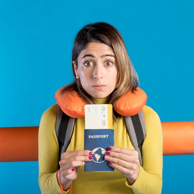 Free photo front view woman holding passport