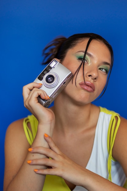 Front view woman holding photo camera