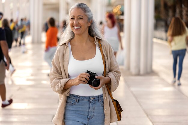 Front view woman holding photo camera