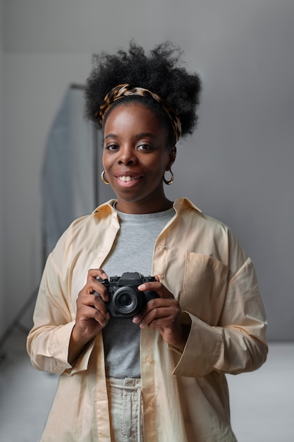 Front view woman holding photo camera