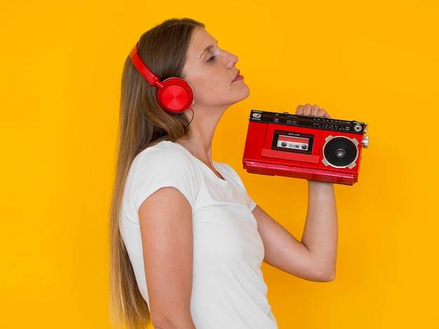 Front view of woman holding a radio