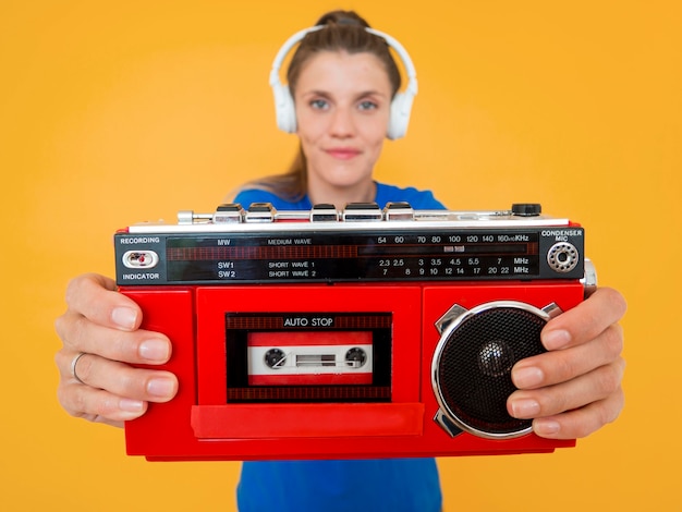 Front view of woman holding a radio