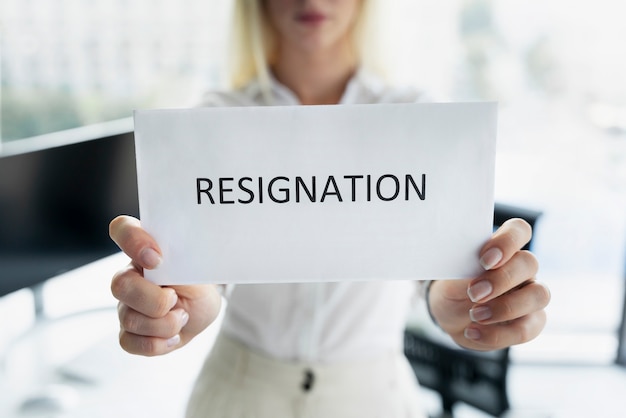 Front view woman holding resignation letter