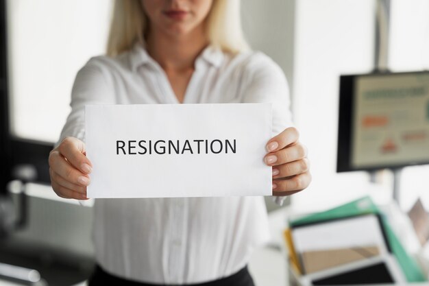 Front view woman holding resignation note