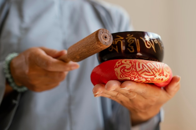 Free photo front view of woman holding singing bowls