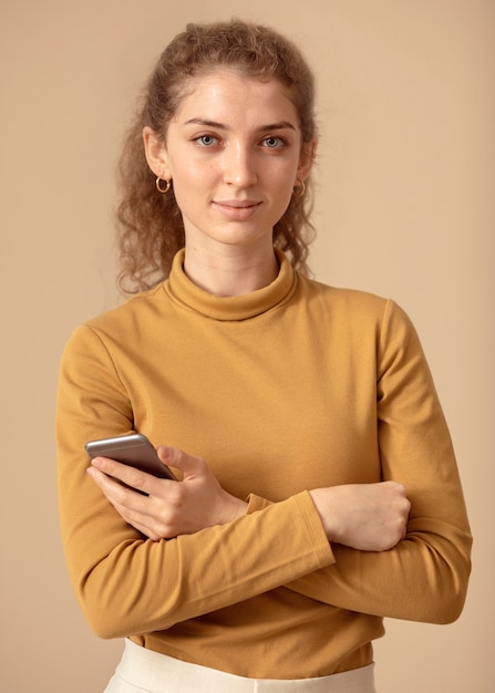 Foto gratuita donna di vista frontale che tiene un telefono astuto