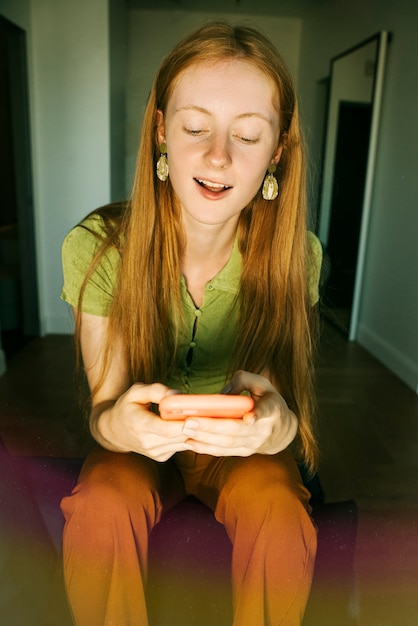 Front view woman holding smartphone