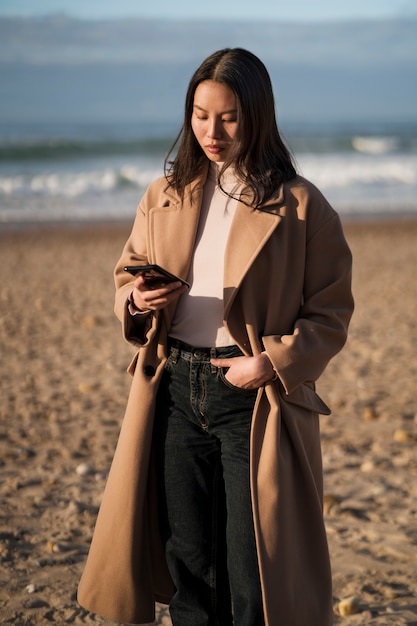 Free photo front view woman holding smartphone