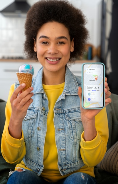 Free photo front view woman holding smartphone