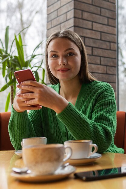 Front view woman holding smartphone