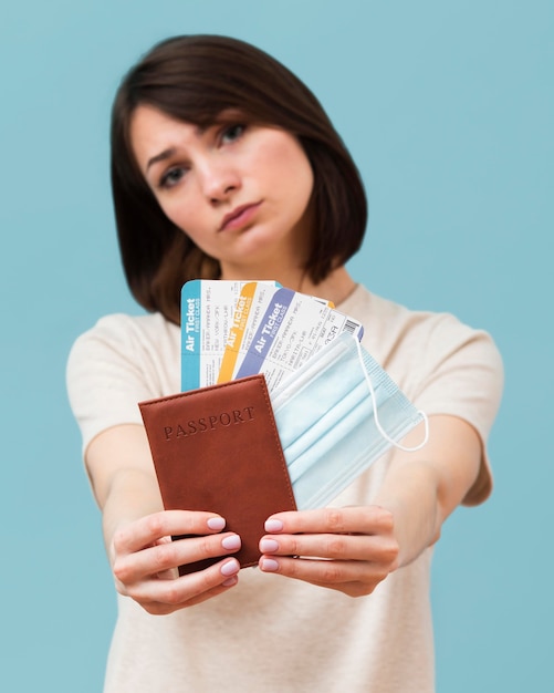 Front view woman holding some airplane tickets