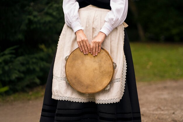 Front view woman holding tambourine