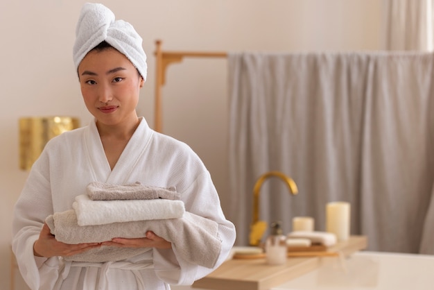 Free photo front view woman holding towels