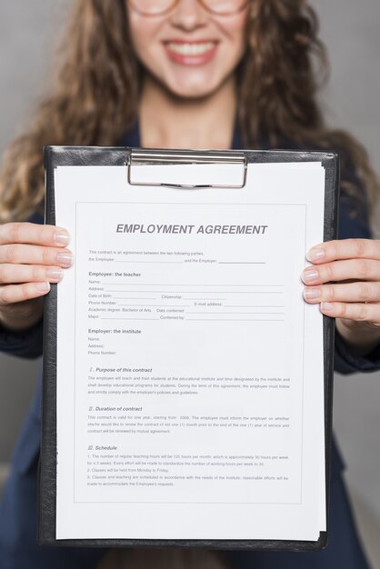 Free photo front view of woman holding up contract for new job