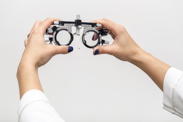 Front view of woman holding up optics equipment