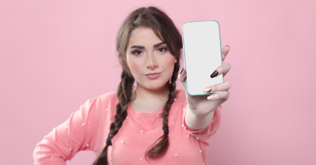 Front view of woman holding up phone