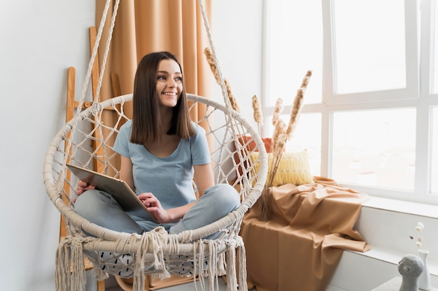 Free photo front view of woman at home with tablet