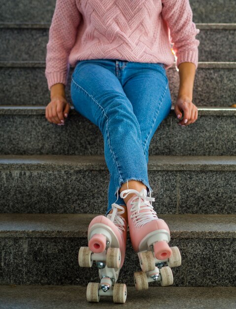 Front view of woman in jeans with roller skates