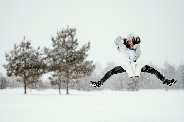 Free photo front view of woman jumping in the air outdoors