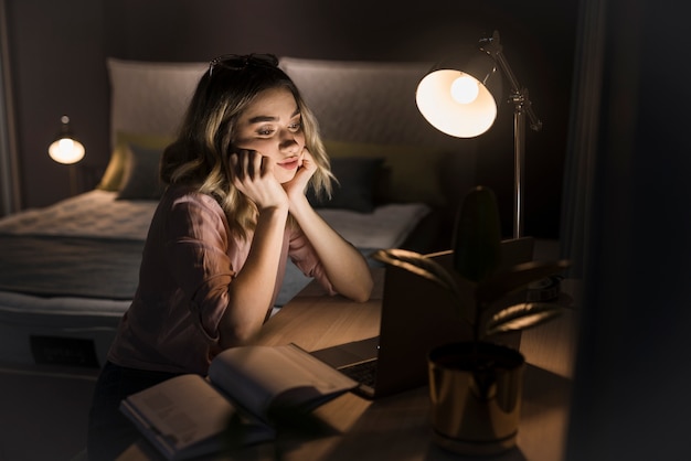 Free photo front view of woman looking at laptop