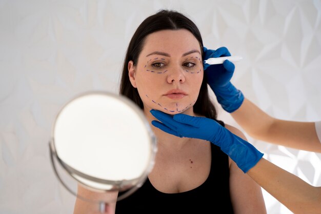 Front view  woman looking in the mirror