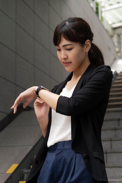 Front view of woman looking at watch