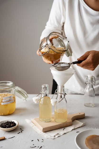 Front view woman making kombucha