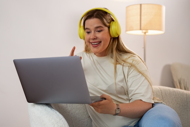 Front view woman making video calls with laptop