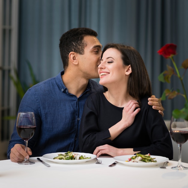 Front view woman and man having a romantic dinner together