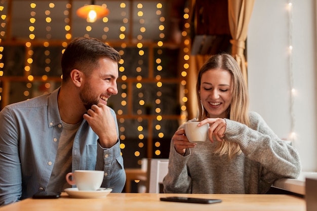 Front view woman and man at restaurant