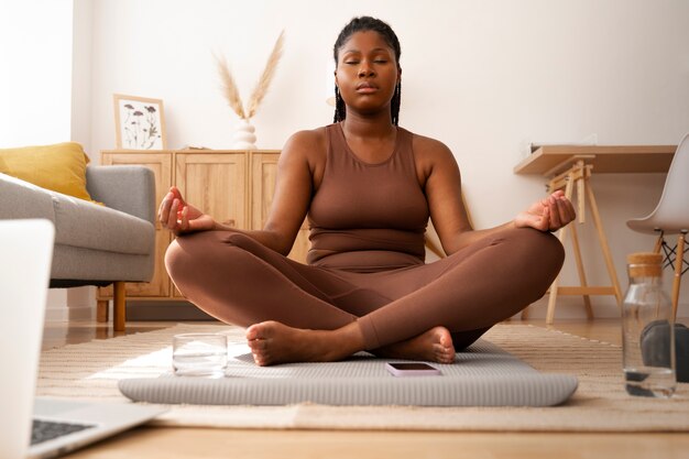 Front view woman meditating at home