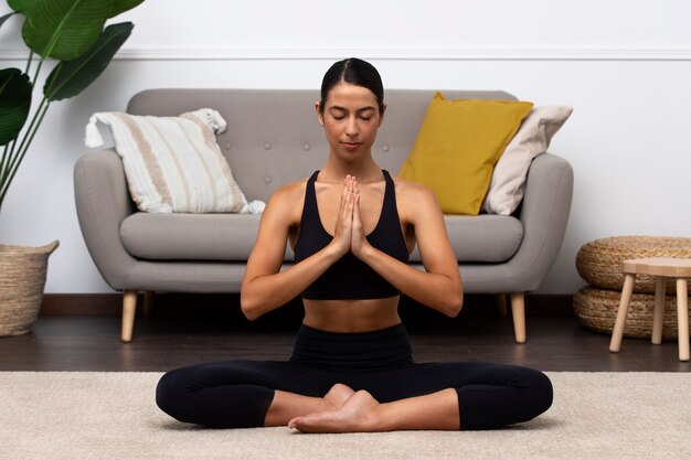 Front view  woman meditating indoors