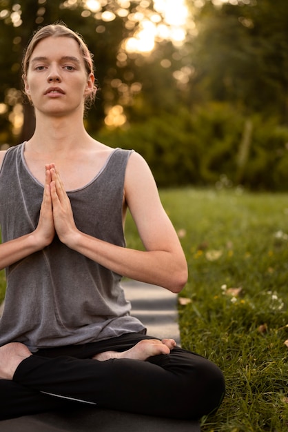 Front view woman meditating outside