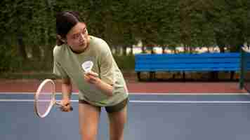 Free photo front view woman playing badminton