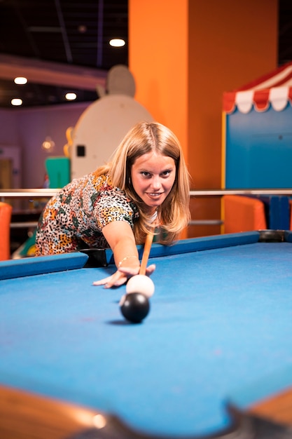 Front view woman playing billiard