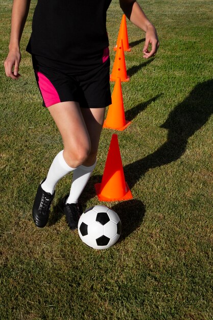 Free photo front view woman playing football