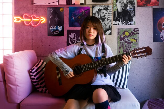 Front view woman playing the guitar indoors