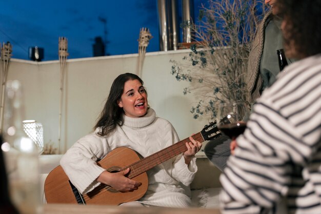 Front view woman playing the guitar