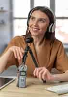 Free photo front view of woman podcasting with microphone