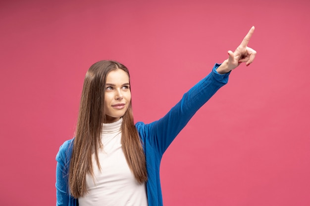 Front view of woman pointing while posing