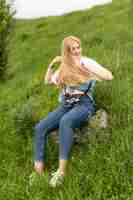 Free photo front view of woman posing in grass