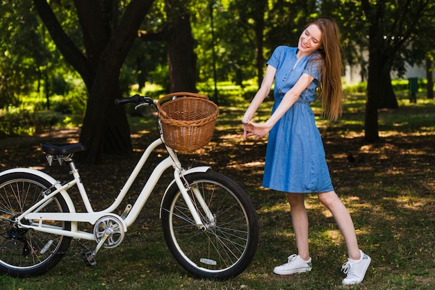 無料写真 フロントビュー女性が自転車の横にポーズ