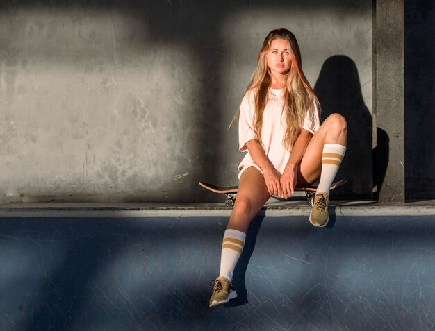 Front view of woman posing at the skating ring with copy space