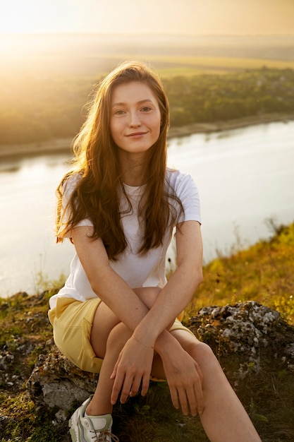 Free photo front view woman posing at sunset