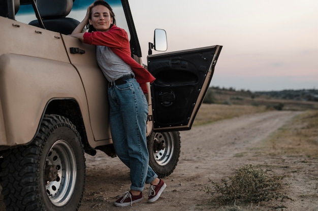 Free photo front view of woman posing while traveling alone by car